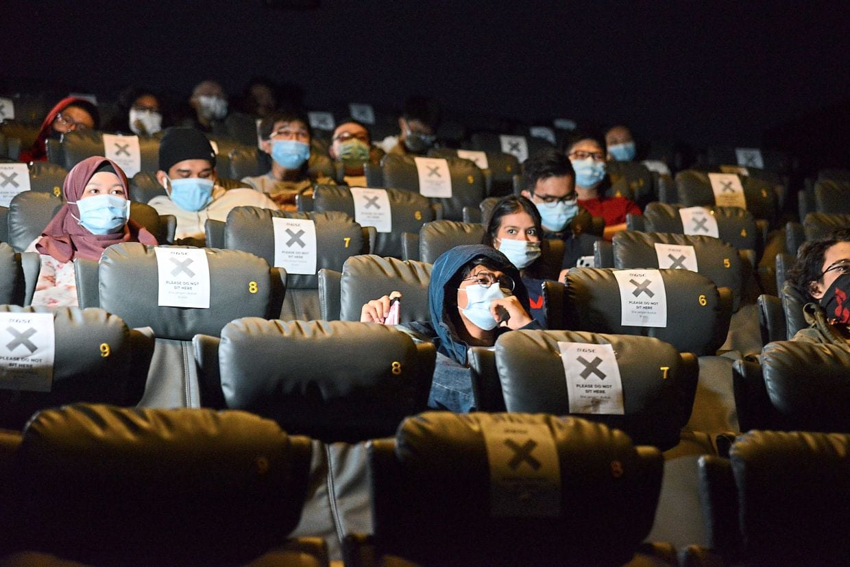 Wearing mask in the cinema is a new norm.