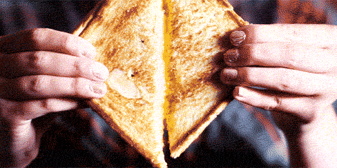 A perfect slice of grilled cheese sandwich with mayo added.